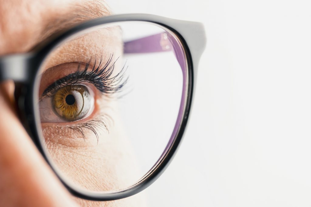Businesswoman eye with glasses close-up